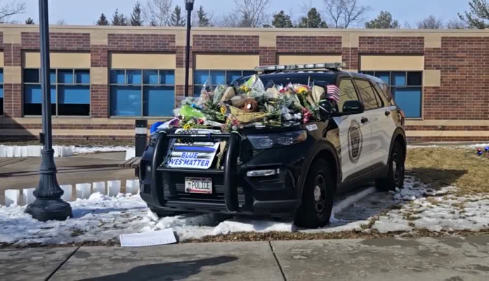 A memorial outside the Burnsville Police Department for officers Paul Elmstrand and Matthew Ruge, and paramedic Adam Finseth.