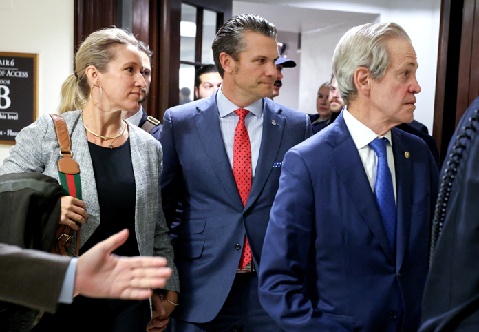 Defense secretary nominee Pete Hegseth, center, with former Sen. Norm Coleman at right, visiting senators on Capitol Hill on Thursday.