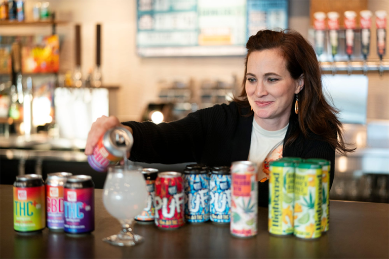 Laura Mullen, co-founder of Bent Paddle Brewing Co., displaying cannabis drink options available at the taproom in Duluth.