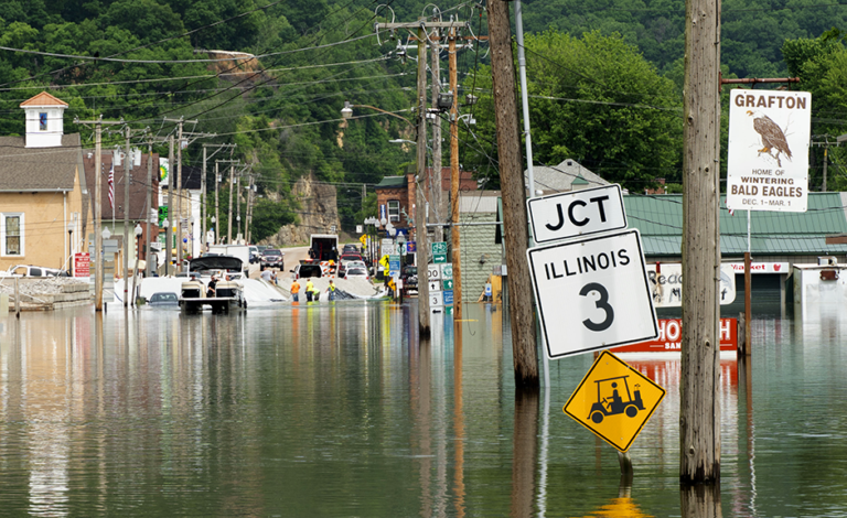 Workers shore up a temporary levee across Main Street in Grafton, Ill., on May 29, 2019. The Mississippi River at Grafton reached its second highest crest ever at 35.17 feet nine days later.