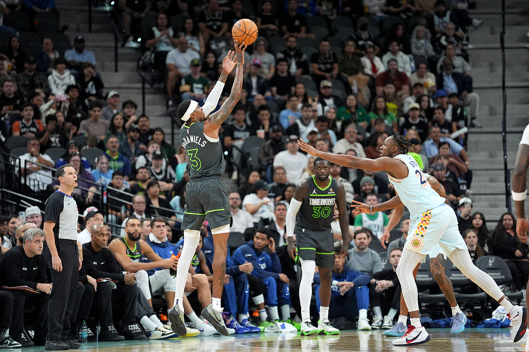 Timberwolves forward Jaden McDaniels shooting over San Antonio Spurs center Charles Bassey in the second half at Frost Bank Center on Sunday.